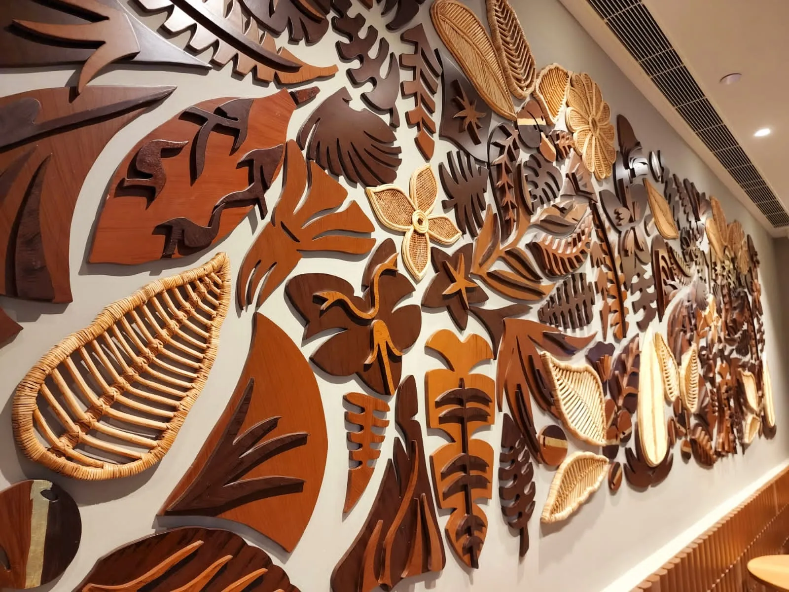 Detail of the woven cane and carved wood coffee-botanical forms at Starbucks HiLITE Mall, Kozhikode
